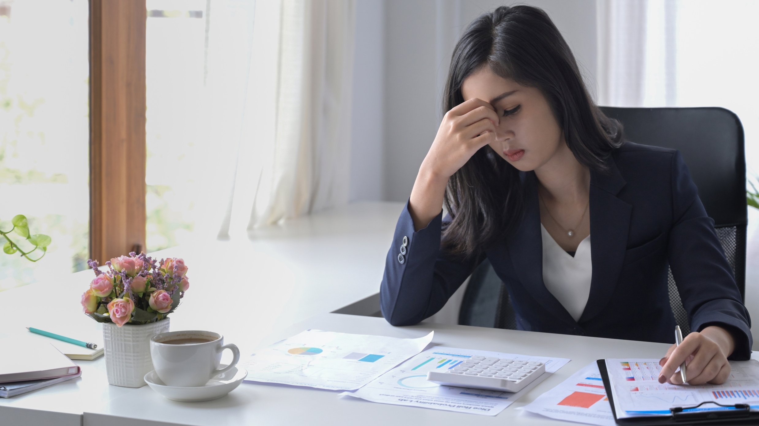 Asian Businesswoman Looking Worried, Tired and Overwhelmed While